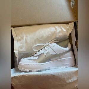 Nike Air Force 1 white and silver trainers,